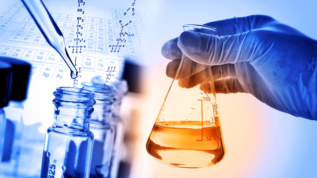 Image showing a hand holding beaker and test tubes in a laboratory